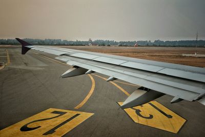Aircraft wing of airplane at runway