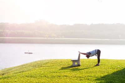 Woman exercising at lakeshore