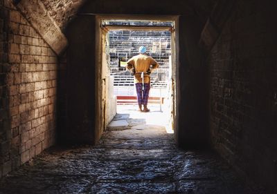 Rear view of man standing in building