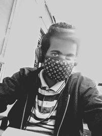 Portrait of young man sitting at home