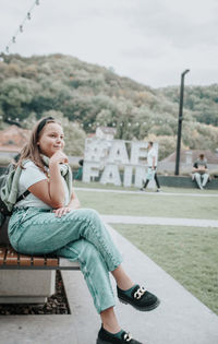 Portrait of woman sitting on field