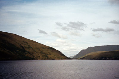 Scenic view of sea and mountains against sky