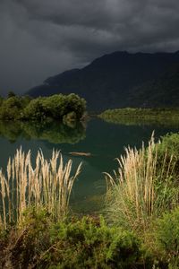 Scenic view of lake and mountains against sky