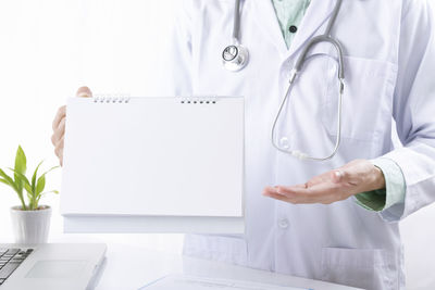 Midsection of person working on table