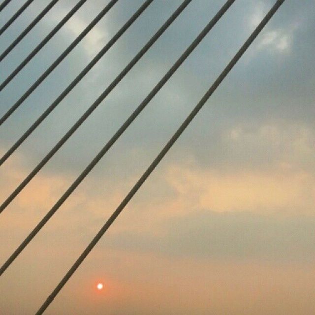 sunset, low angle view, sky, sun, orange color, silhouette, cloud - sky, nature, beauty in nature, sunlight, connection, no people, power line, tranquility, scenics, outdoors, backgrounds, electricity, cloud, cable