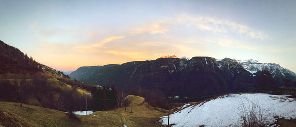 Scenic view of snowcapped mountains against sky during sunset