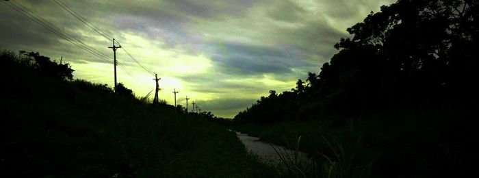 Scenic view of silhouette field against sky during sunset