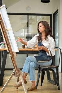 Woman sitting on chair at table