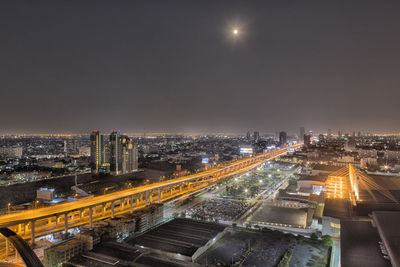 Aerial view of city lit up at night