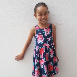 Smiling girl standing against wall