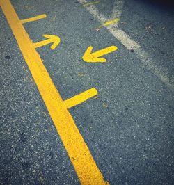 High angle view of arrow sign on road