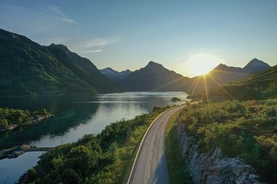 Scenic view of lake and mountains against sky during sunset