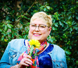 Portrait of woman holding flower