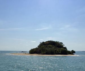 Scenic view of island in sea against sky