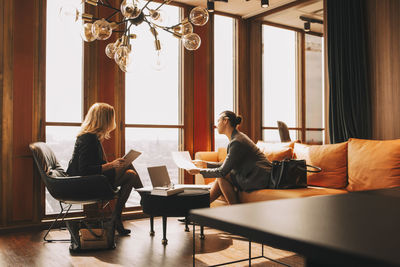 Legal colleagues discussing over documents in law office