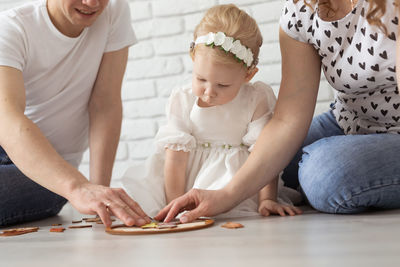 High angle view of mother and daughter sitting on table