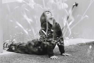 Double exposure of woman exercising on staircase with plant