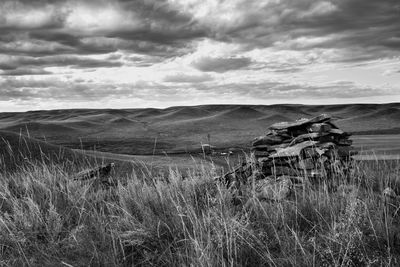 Scenic view of field against cloudy sky