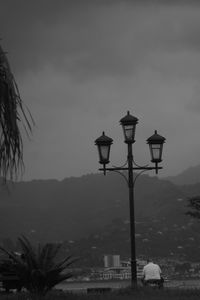 Street light and buildings against sky