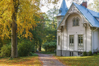 White wooden house with a garden walk