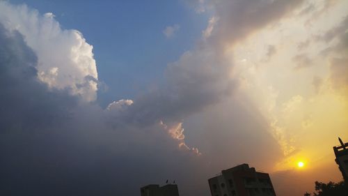 Low angle view of building against cloudy sky