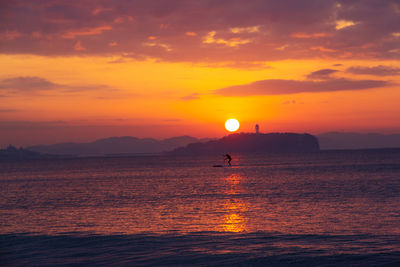 Scenic view of sea against orange sky