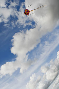 Low angle view of kite flying against sky