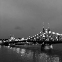 Bridge over river with buildings in background