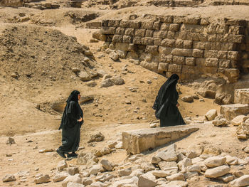 Rear view of woman on rock