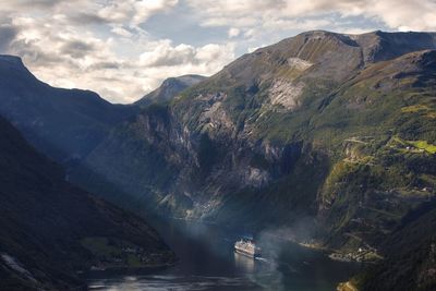 High angle view of ship moving from fjord on sea