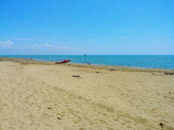 Scenic view of beach against blue sky