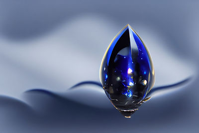 A blue crystal in a droplet shape