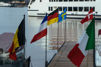 National flags on pier over river