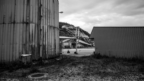 Built structure on farm against cloudy sky