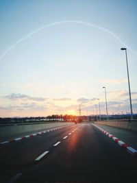 Highway against sky during sunset