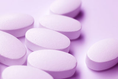 Close-up of medicines over purple background