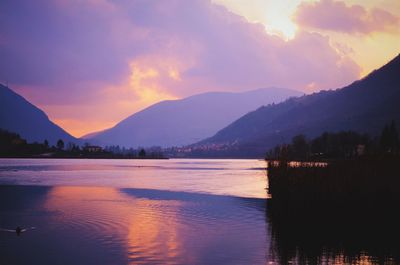 Scenic view of lake and mountains during sunset