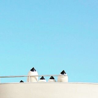 HIGH SECTION OF BUILT STRUCTURE AGAINST CLEAR BLUE SKY WITH LIGHT