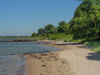 Scenic view of beach against clear sky