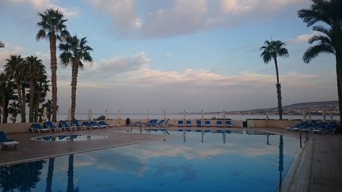 Scenic view of swimming pool by sea against sky