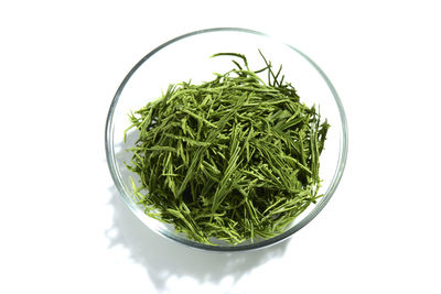 High angle view of vegetables in bowl against white background