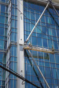 Men on scaffolding of modern building