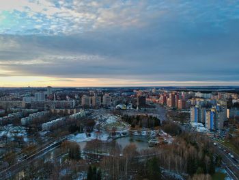 High angle view of buildings against cloudy sky