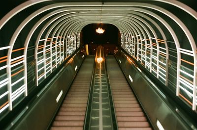 Low angle view of illuminated staircase in tunnel