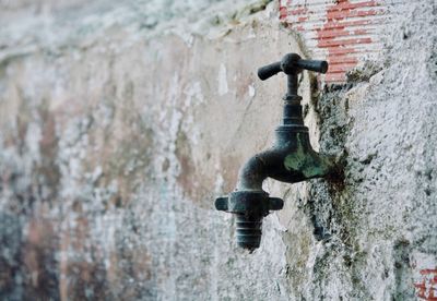 Close-up of water pipe against wall