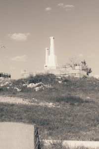 Lighthouse on landscape against sky