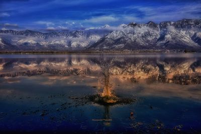 Scenic view of lake against sky during winter