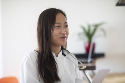 Young asia female doctor with report in a practice
