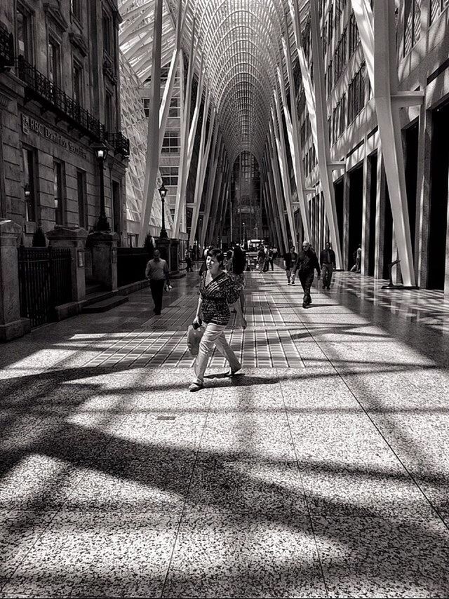 walking, lifestyles, full length, men, leisure activity, person, rear view, togetherness, architecture, built structure, the way forward, building exterior, city life, bonding, city, sunlight, day