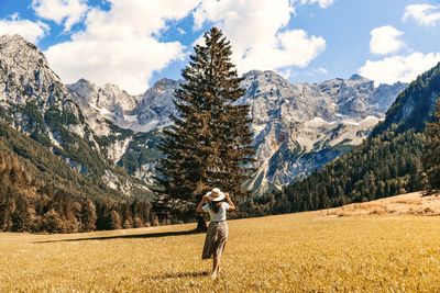 Full length of man climbing on mountain against sky